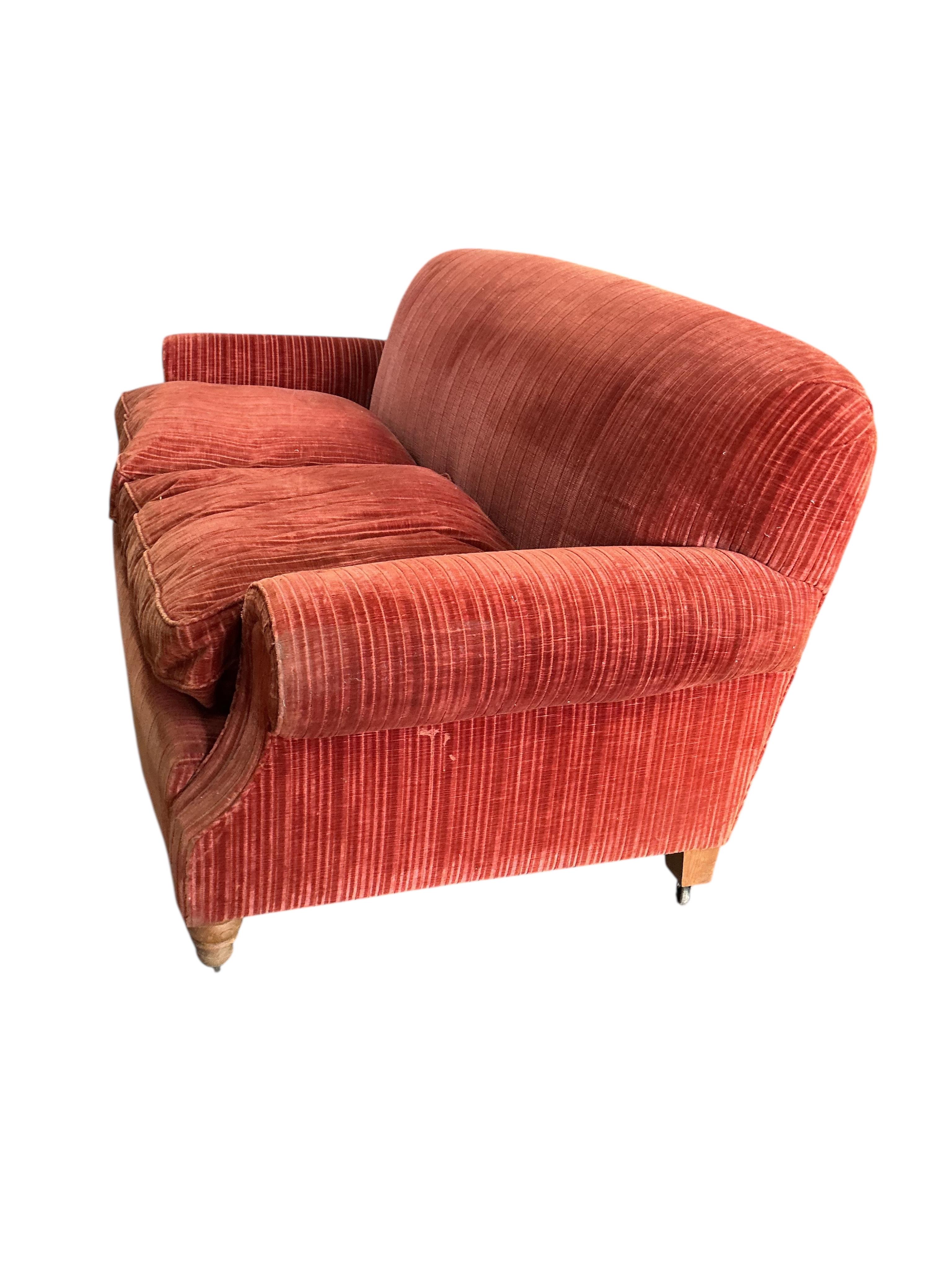 A modern Howard style upholstered two seater settee, width 206cm, depth 92cm, height 84cm, Provenance: The late Kenneth Turner (1936-2025), celebrity florist, designer and perfume retailer, he received the Royal Warrant
